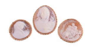 Three shell cameo brooches ; the first carved with a windswept maiden, signed G Noto, within a