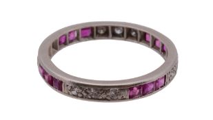 A ruby and diamond eternity ring, the trio's of eight cut diamonds interspaced by trio's of step