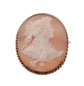 A shell cameo brooch, the oval cameo carved with the profile of Hemera with flowers in her hair,