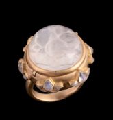 A moonstone ring, the circular shaped cabochon moonstone in a hinged collet setting opening to