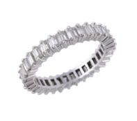 A diamond eternity ring , the ring set with baguette cut diamonds, approximately 0.96 carats total,