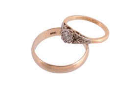 A diamond solitaire ring and a gold wedding band, the single brilliant cut diamond in a claw