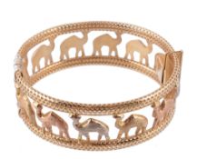 A gold coloured camel bracelet, the hinged bangle composed of textured camels within a pierced