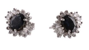 A pair of sapphire and diamond ear studs, the oval cut sapphires within a surround of brilliant cut