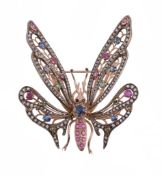 A gem set butterfly brooch, the body set with circular shaped rubies and a circular shaped