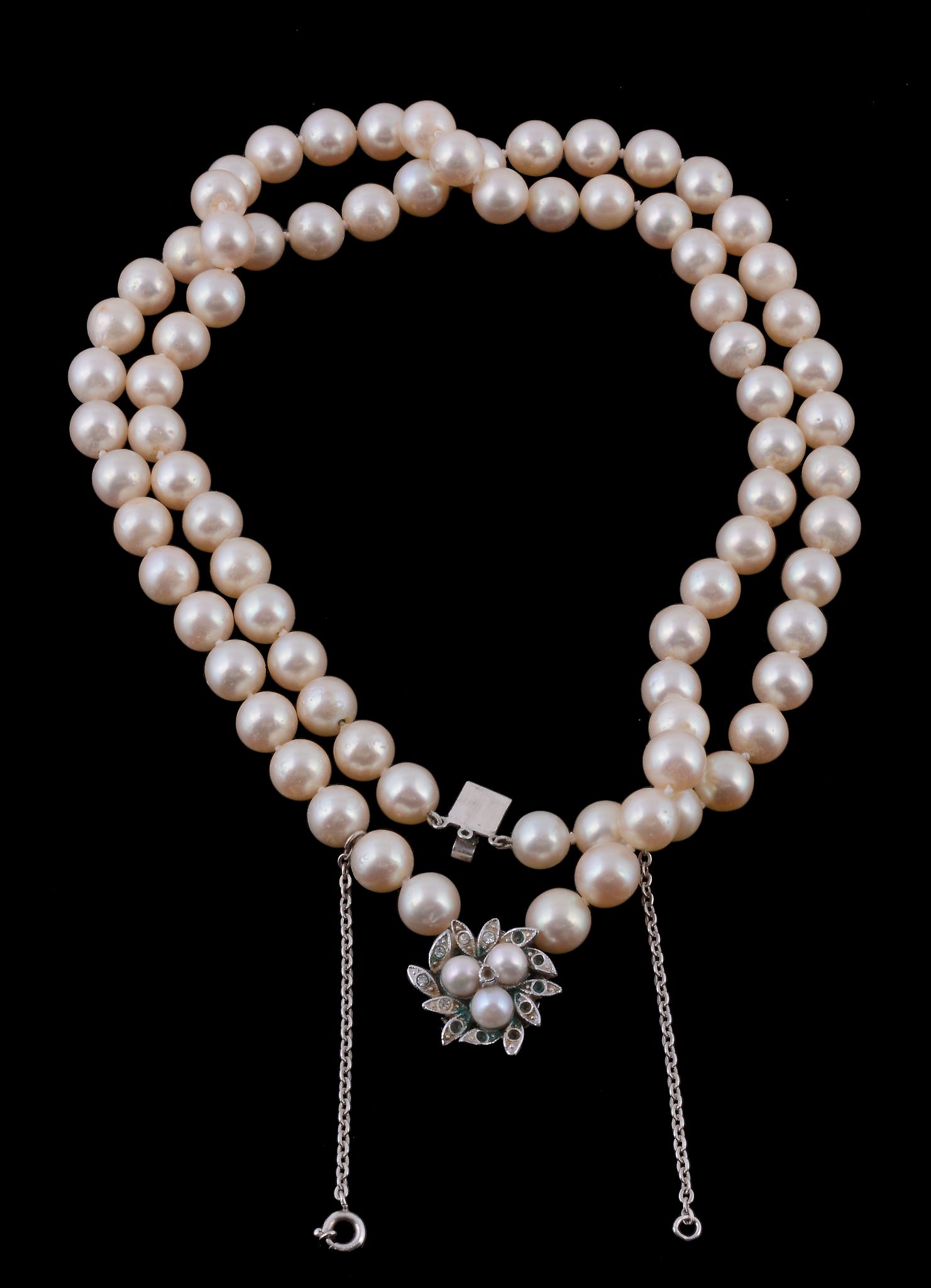 A two row cultured pearl necklace, composed of uniform cultured pearls, to a concealed clasp set