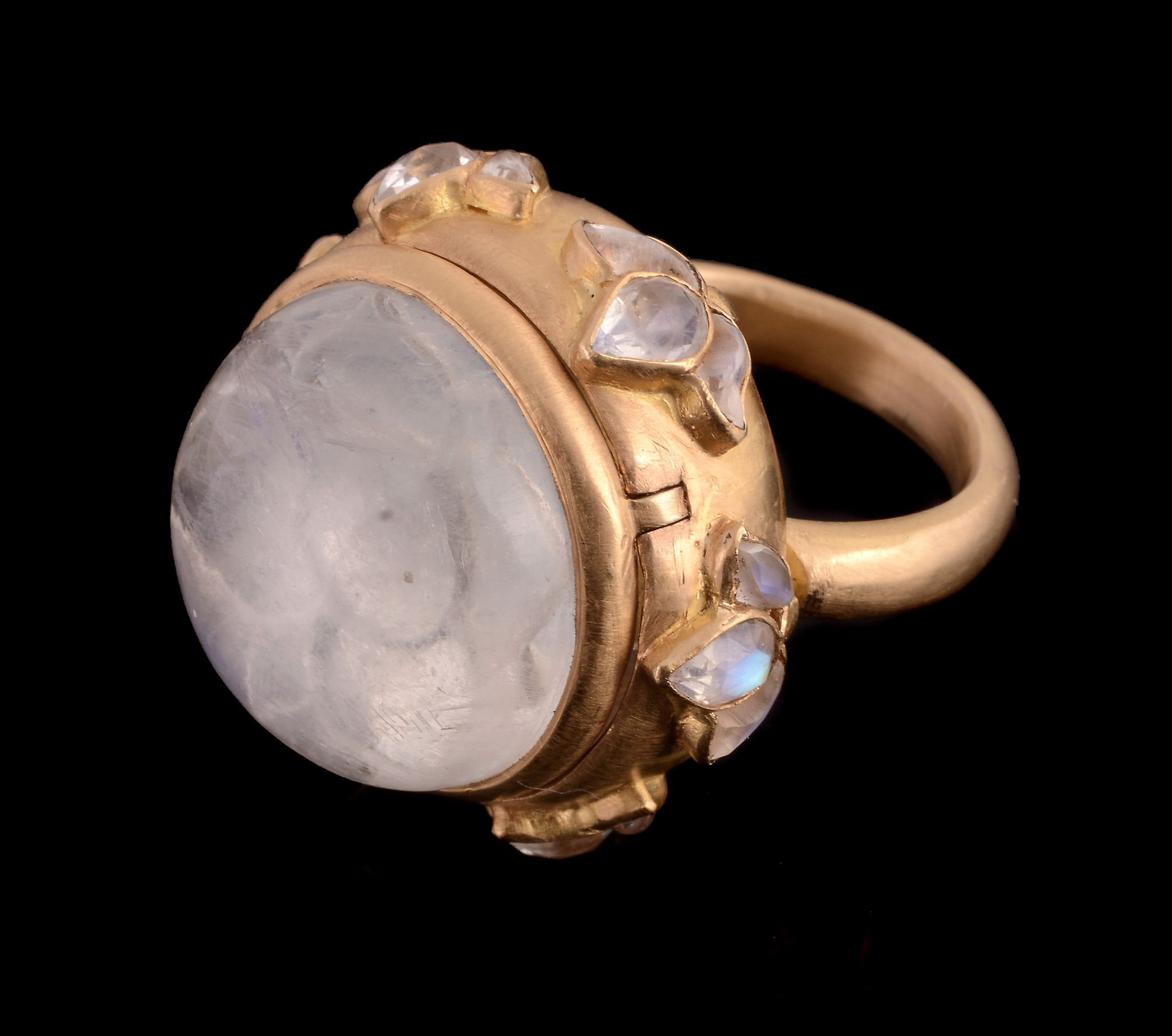 A moonstone ring, the circular shaped cabochon moonstone in a hinged collet setting opening to - Image 3 of 3
