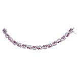 A ruby and diamond bracelet, the articulated bracelet set with marquise shaped and circular shaped