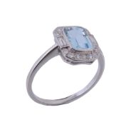 An aquamarine and diamond ring, the central rectangular shaped aquamarine collet set within a