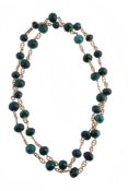 A malachite bead necklace, composed of polished malachite beads, with rope twist links in between,