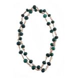 A malachite bead necklace, composed of polished malachite beads, with rope twist links in between,