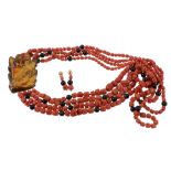 A coral and amber necklace, the four graduated strands of coral with facetted black beads, to an