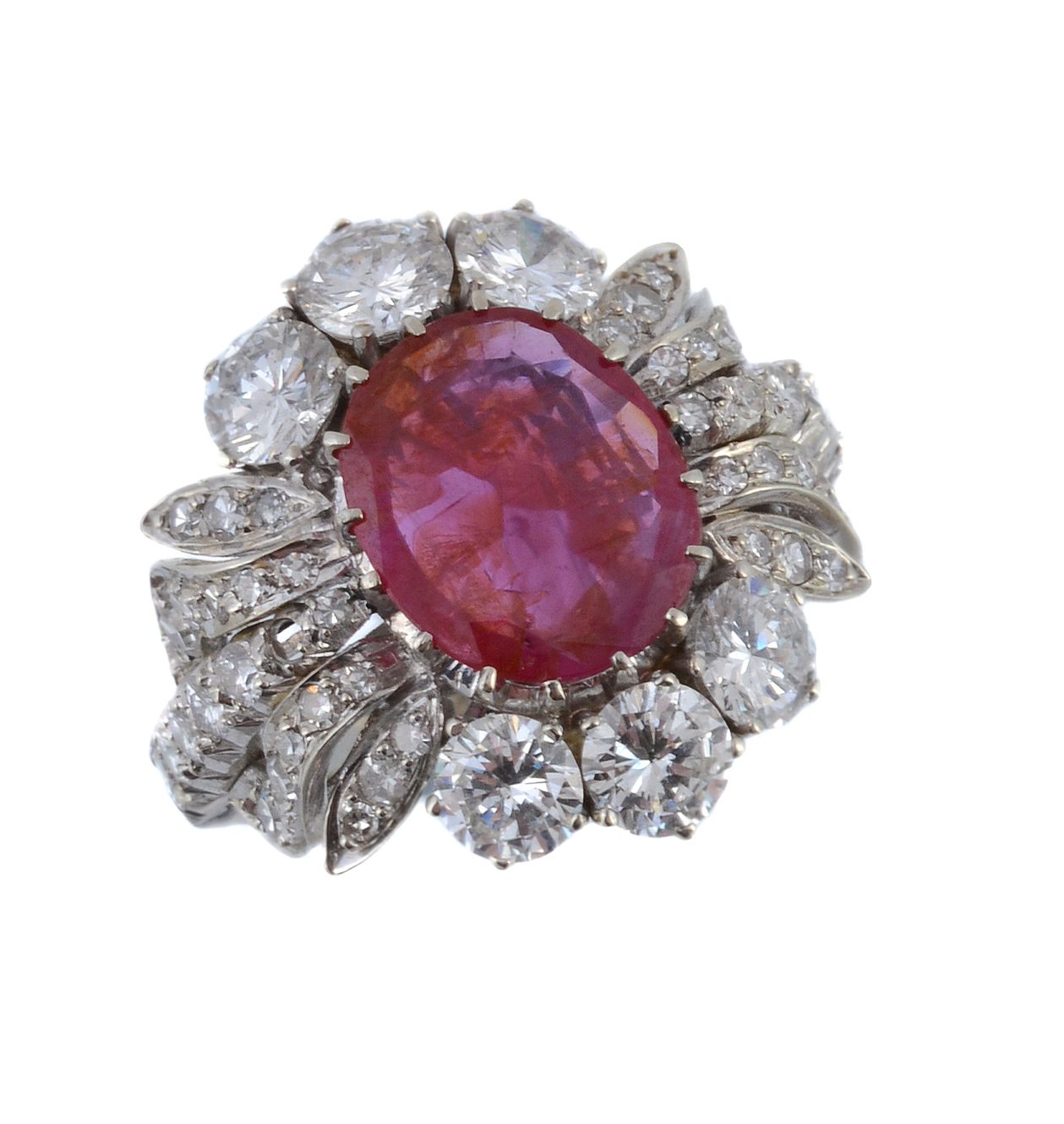A ruby and diamond cluster dress ring, the central oval mixed cut ruby within a pierced brilliant