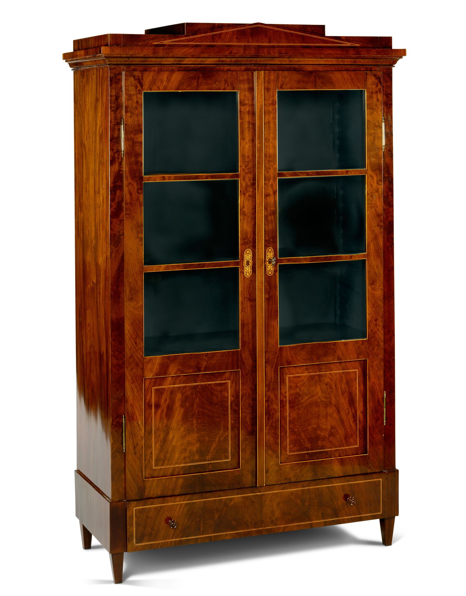 A Berlin Mahogany Armoire Germany circa 1825, having a stepped pediment inlaid with boxwood
