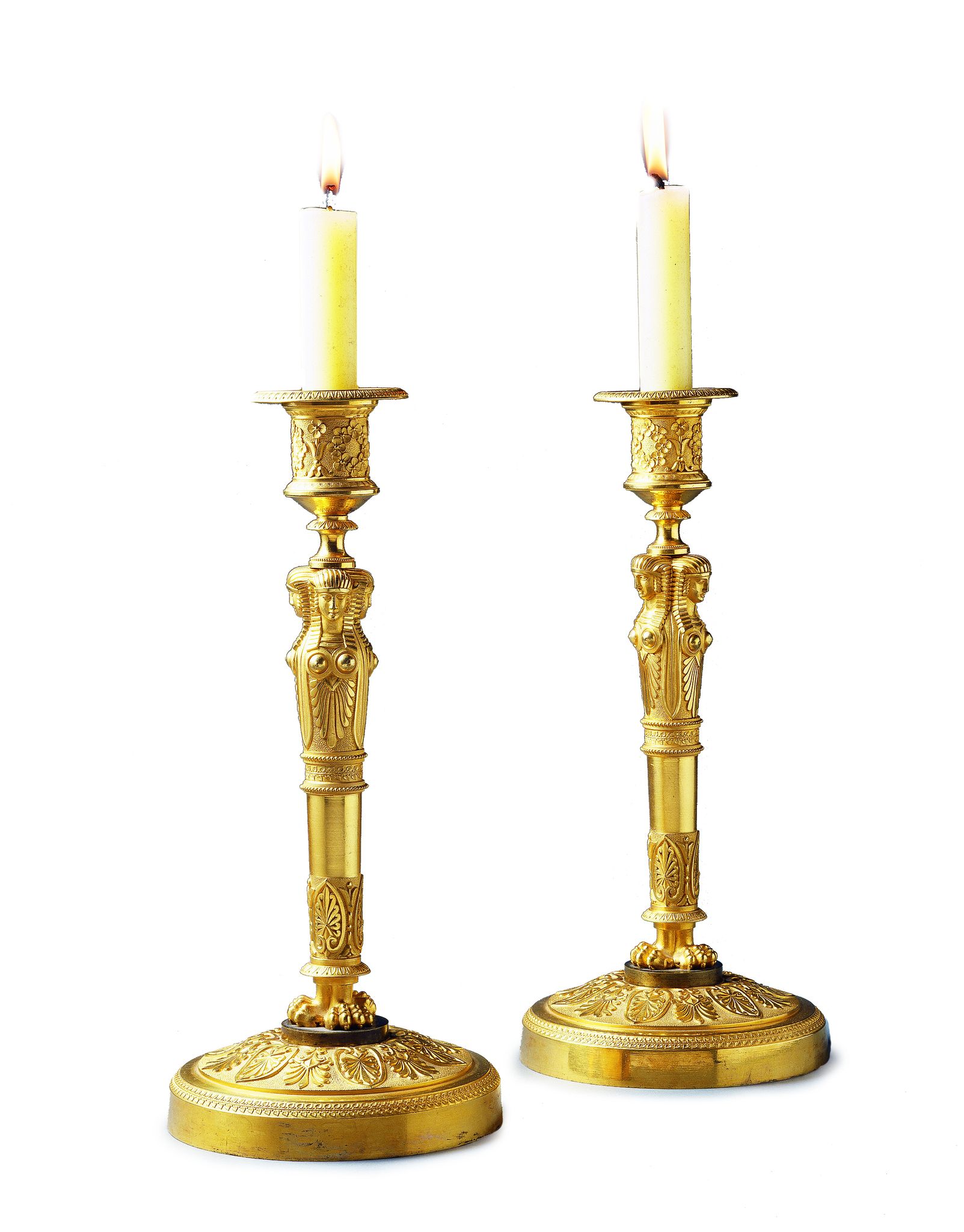 A Pair of Empire Gilt Bronze Candlesticks France circa 1810, the socles enriched with machined neo-