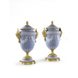 A Pair of Ormolu Wedgwood Vases England circa 1850, decorated in the traditional manner with white
