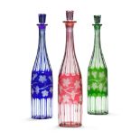 A Set of Glass Bottles in Three Colours England circa 1900, of red, green and blue, each cut with