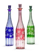 A Set of Glass Bottles in Three Colours England circa 1900, of red, green and blue, each cut with