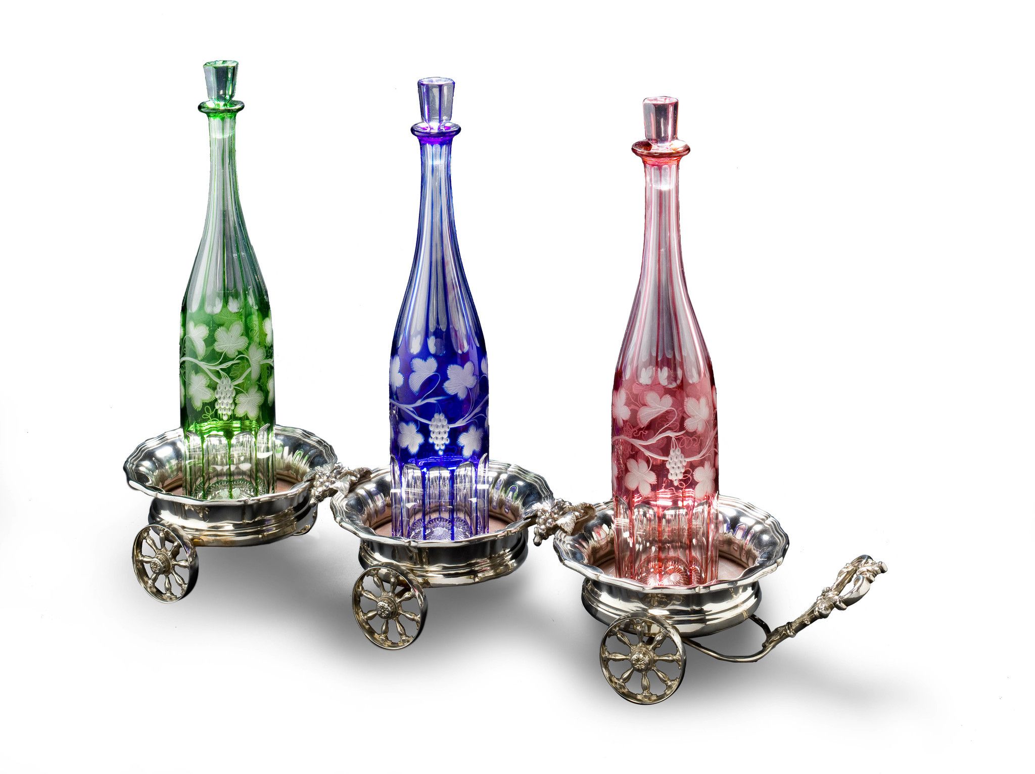 A Silver Plate Triple Decanter Trolley England circa 1890, with Bacchanalian decoration of vines and