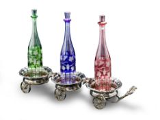 A Silver Plate Triple Decanter Trolley England circa 1890, with Bacchanalian decoration of vines and
