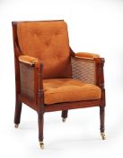 A Pair of Regency Library Armchairs England circa 1820, of large scale with caned seat, back and
