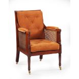 A Pair of Regency Library Armchairs England circa 1820, of large scale with caned seat, back and