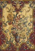 An Early 18th Century Tapestry Panel France circa 1720, depicting a flower-filled urn, with exotic