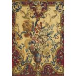 An Early 18th Century Tapestry Panel France circa 1720, depicting a flower-filled urn, with exotic