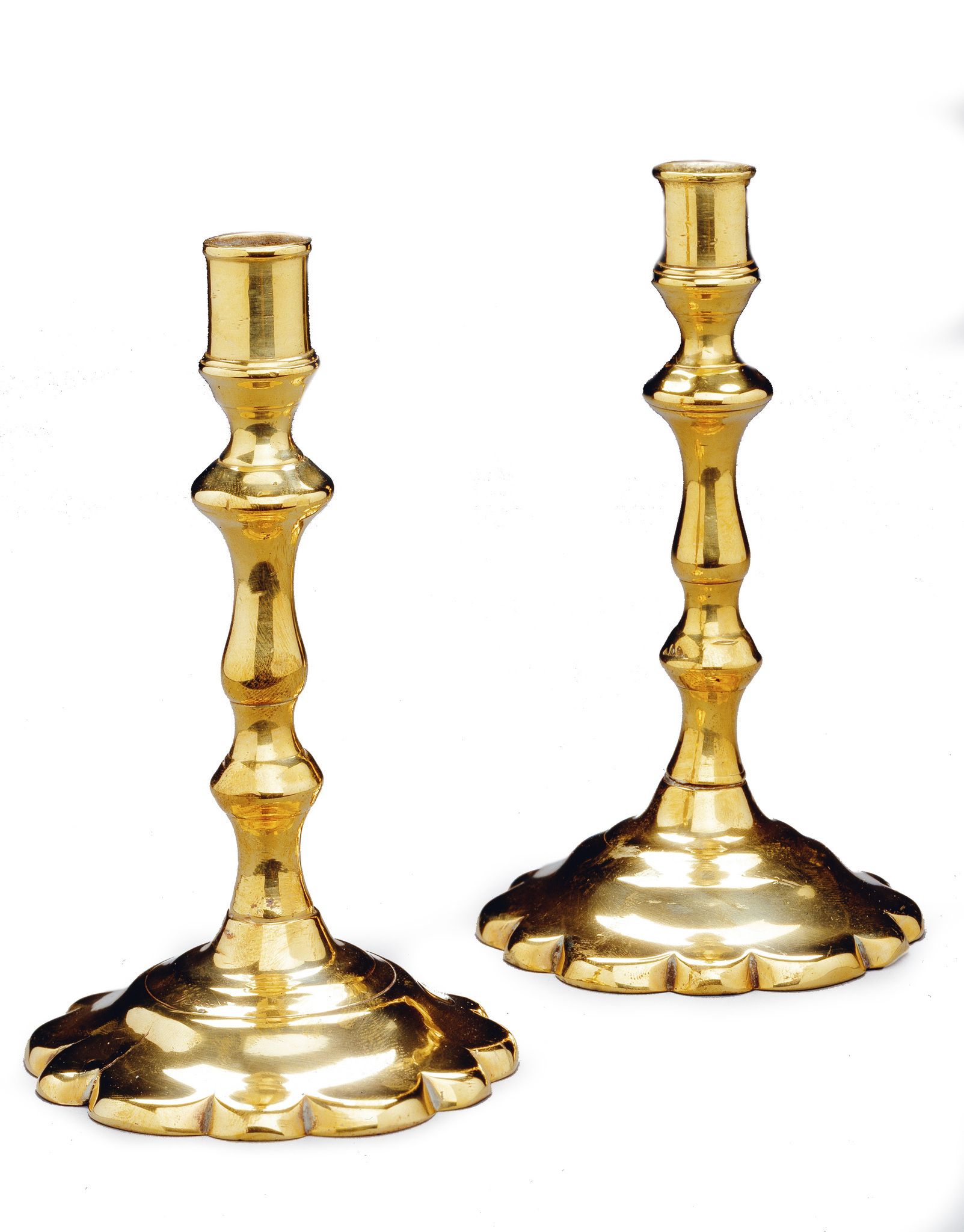 A Pair of Queen Anne Brass Tapersticks England circa 1705, with scalloped circular bases,  13cm