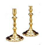 A Pair of Queen Anne Brass Tapersticks England circa 1705, with scalloped circular bases,  13cm