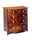 A George III Miniature Mahogany Chest of Drawers England circa 1800, the finely figured top above