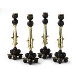 A Rare Set of Four Candlesticks 19th century, modelled in the form of cannon,      supported on a