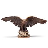 A 19th Century Carved Wood Eagle Switzerland circa 1880, of an open winged eagle perched on a rock
