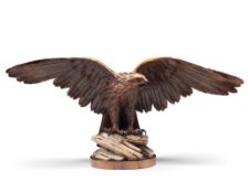 A 19th Century Carved Wood Eagle Switzerland circa 1880, of an open winged eagle perched on a rock