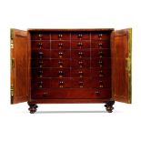 A Regency Miniature Mahogany Cabinet England circa 1810,  the flame veneered mahogany doors with