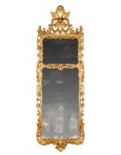A Pair of George III Pier Mirrors England circa 1760, the frames extravagantly carved with