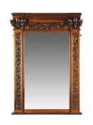 A Pair of Carved Walnut Mirrors Italy circa 1859, attributed to Angelo Barbetti, the top frieze is