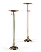 A Pair of Telescopic Brass Torcheres England circa 1880, the circular dished tops above square