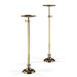 A Pair of Telescopic Brass Torcheres England circa 1880, the circular dished tops above square