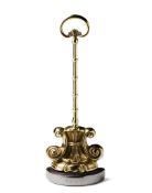 A Scroll Form Brass Doorstop England circa 1840, with a rose petal base, the stem with turnings,