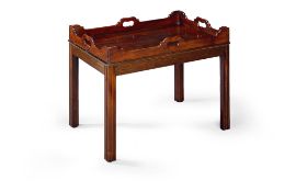 A Mahogany Tray Table England circa 1800, the shaped gallery with pierced carrying handles,