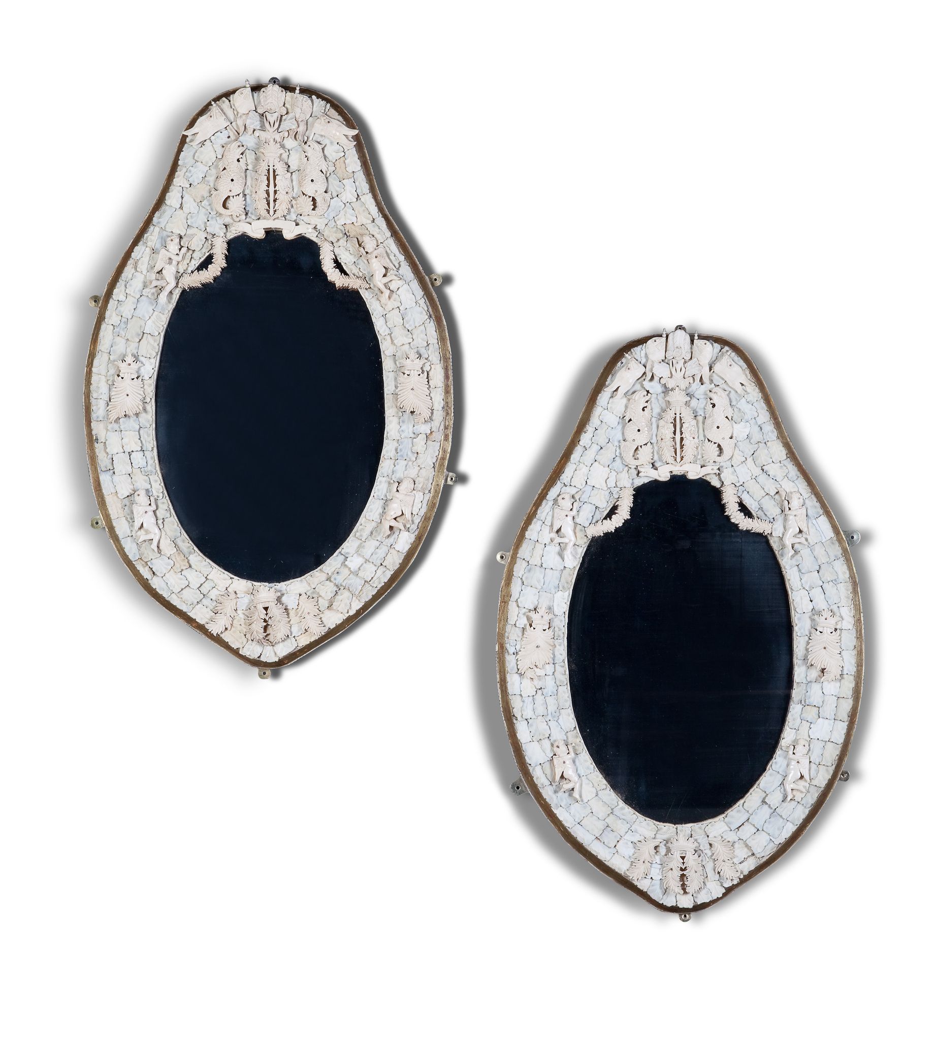 A Pair of Dieppe Mirrors France circa 1880, the oval plates within an applied carved ivory frame