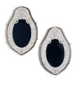 A Pair of Dieppe Mirrors France circa 1880, the oval plates within an applied carved ivory frame