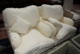 A pair of Multi York Howard design armchairs in pale yellow covers.