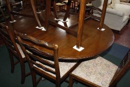 A Georgian style mahogany twin pedestal dining table, set of eight ladder back dining chairs and a