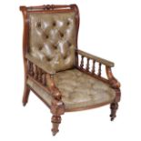 A Victorian mahogany and leather upholstered library chair, circa 1860, with turned top rail above