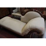 A Victorian mahogany framed and upholstered chaise longue, with shaped back and scrolled arm support