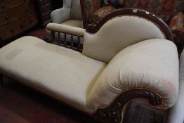 A Victorian mahogany framed and upholstered chaise longue, with shaped back and scrolled arm support