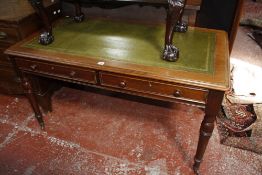 A Victorian writing table, mid 19th century, the rectangular top with leather inset writing