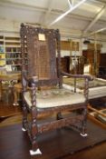 A late 17th century and later oak and caned carved open armchair